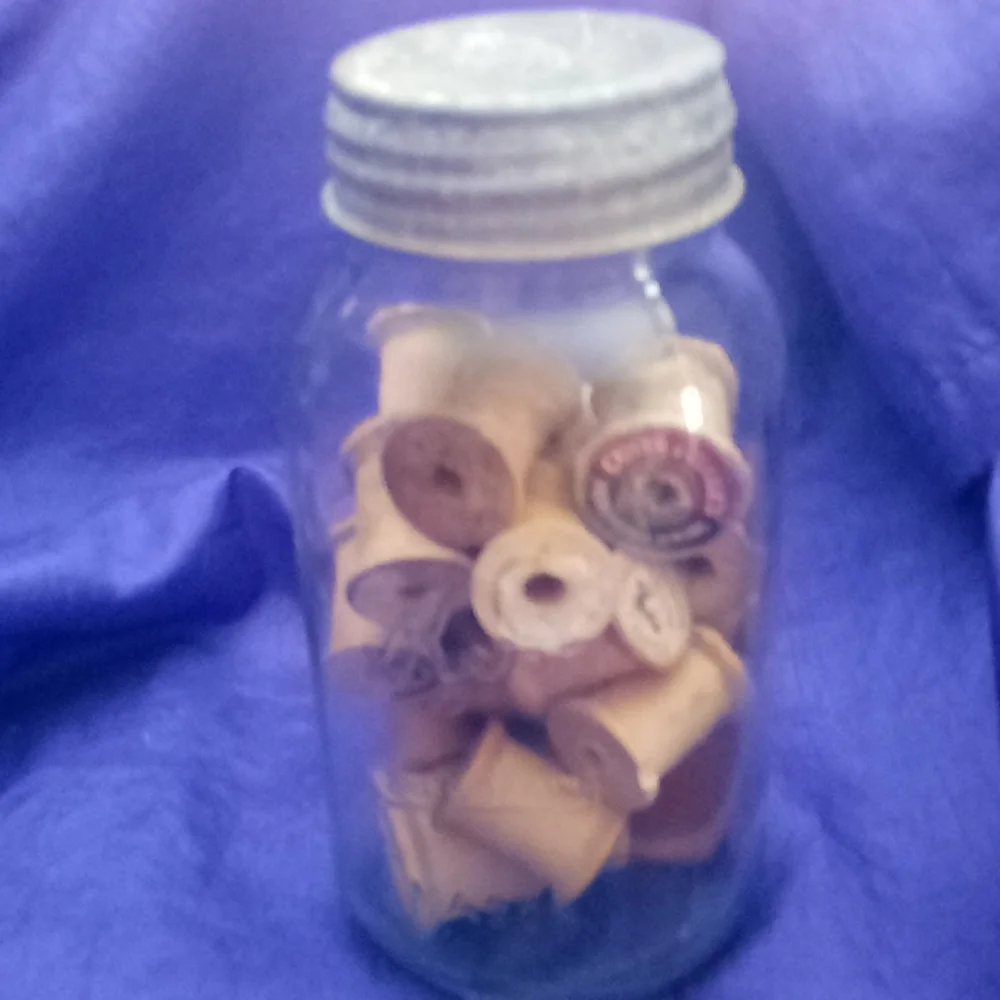 Vintage kerr Mason jar with 25 vintage wooden thread spools and a zinc l…